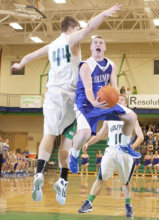 <p>Columbia Falls guard Parker Johnson (center) is contested by
Glacier's Ryan Edwards (44) during the first half of Glacier's home
game against Columbia Falls Friday night.</p>