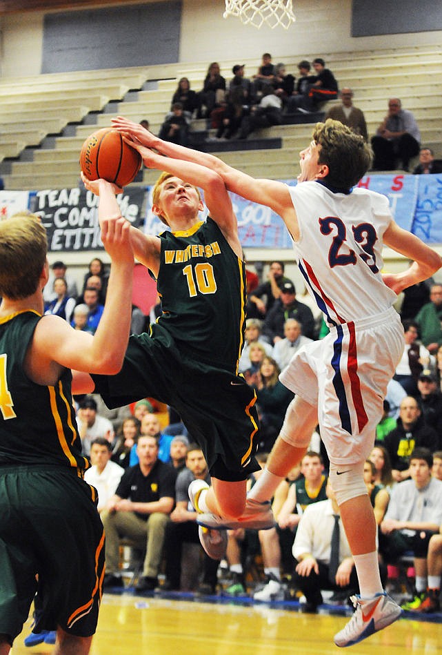 <p>Whitefish's Zander Wold is fouled by Columbia Falls' Steven DeCamp as he goes up for a shot during the third quarter. (Aaric Bryan/Daily Inter Lake)</p>