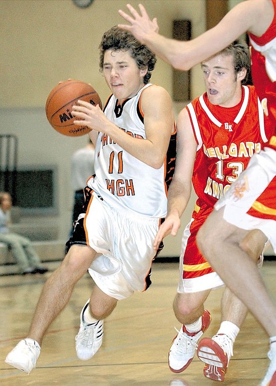 Karen Nichols/Daily Inter Lake&lt;br&gt;Flathead guard Ryan Gregg presses toward the basket while Missoula Hellgate's Joe Johnson defends during fourth quarter play Thursday night in Kalispell. The Knights dominated Flathead 62-37.