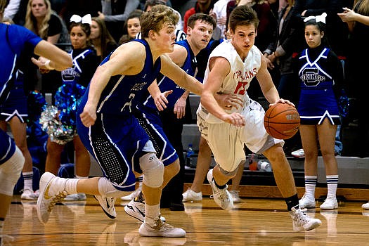 &lt;p&gt;Post Falls' David Bourgard drives to the key past Coeur d'Alene's Joey Naccarato, left, and Austin Lee on Tuesday at Post Falls High School.&lt;/p&gt;