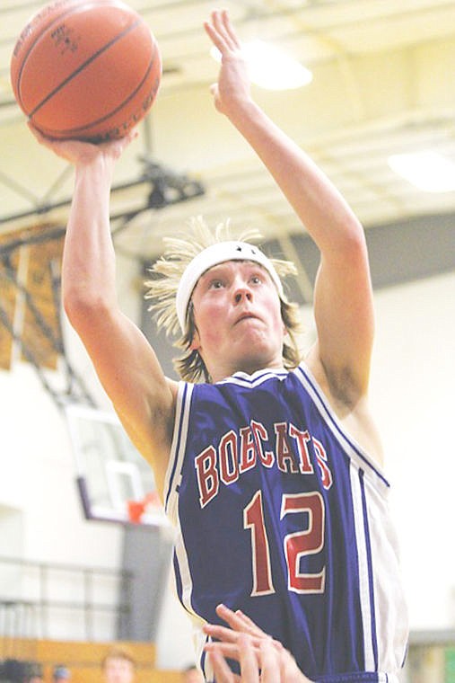 <p>Tucker Smith prepares to shoot for the basket at the Superior Bobcat's game in Charlo.</p>