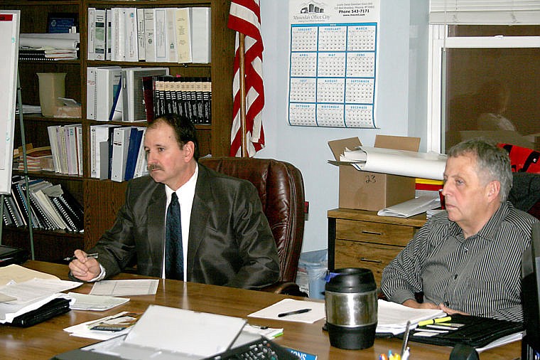 &lt;p&gt;Commissioners Ronan Zylawy and Duane Simons listen to proposal from DIS Technologies for network upgrades to the sheriff's office.&lt;/p&gt;