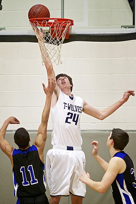 <p>Lake City High's Riley Moreen goes up to tip in a shot during the T-Wolves game Friday against Coeur d'Alene High.</p>