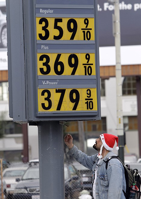 &lt;p&gt;A man looks up at a marquee with high gas prices at a Shell gas station in San Francisco in December 2010.&lt;/p&gt;