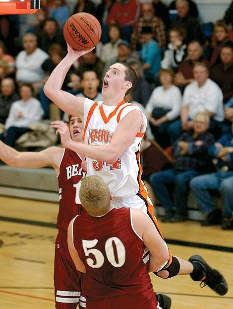 Flathead&#146;s Jason Russell goes up for the basket while Helena&#146;s Drew Waltee defends during first-half action Saturday night in Kalispell. Flathead won 74-43 as four of its five starters reached double-figure scoring. Karen Nichols/Daily Inter Lake