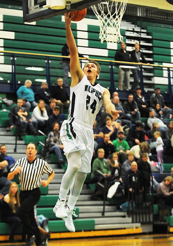 <p>The Wolfpack's Tadan Gilman scores a basket on a fastbreak during the first quarter against Frenchtown on Friday. (Aaric Bryan/Daily Inter Lake)</p>