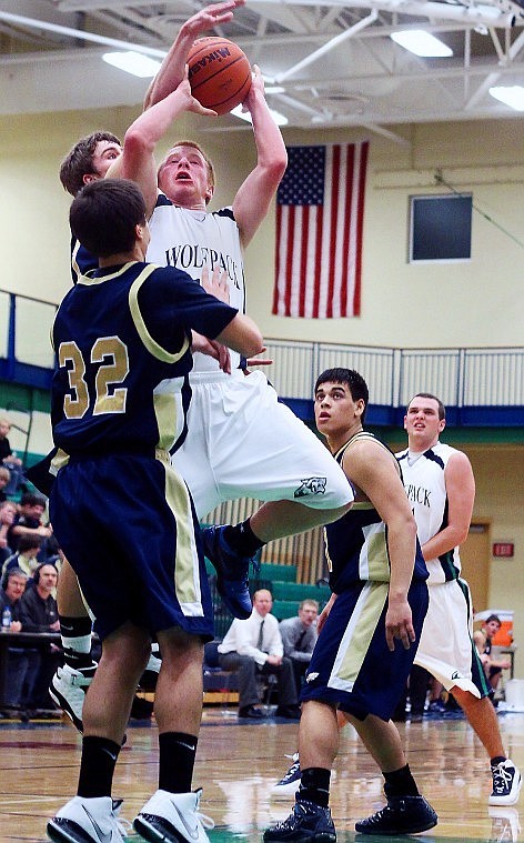 Glaciers Grahm Schmaltz hangs in the air for a shot while Missoula Big Skys Jordan Schafer puts an arm up to defend in the fourth quarter of Thursday evenings game in Kalispell.