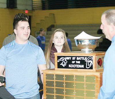 &lt;p&gt;LHS Vice Principal Jim Germany, right, presents the Highway 37 Battle of the Kootenai trophy to Eureka Tuesday, Jan. 12, 2016.&lt;/p&gt;