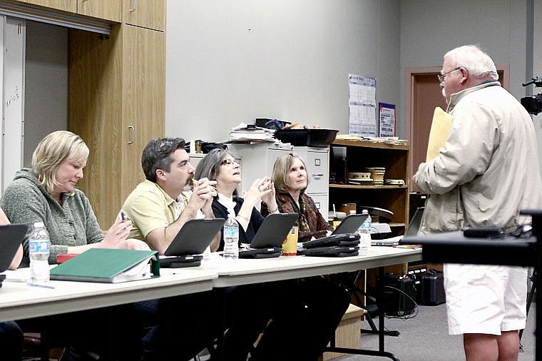 &lt;p&gt;John Cheesman presents the St. Regis School Board of Trustees with a petition during a meeting Jan. 9.&lt;/p&gt;