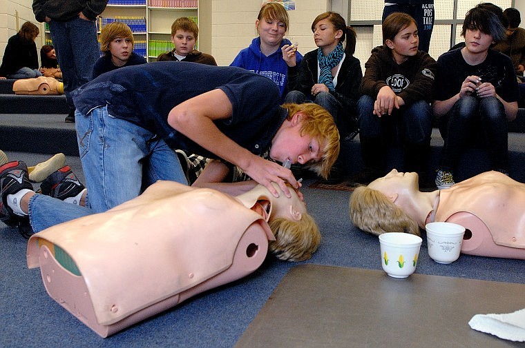 Kalispell Middle School seventh-grader Sylas Schutt blows air into a dummy during a CPR training session in health class Thursday morning. Proponents of consolidation say consolidating rural schools would give middle-school students a wider variety of educational and extracurricular options.