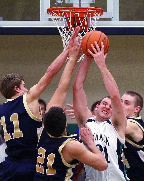 Glaciers Shay Smithwick-Hann pulls down a defensive rebound while surronded by a trio of Missoula Big Sky Eagles on Thursday at Glacier.