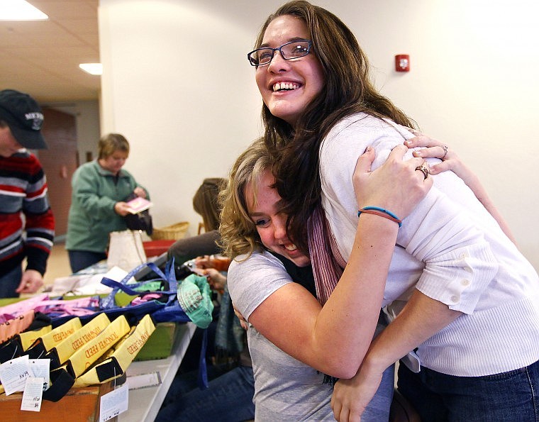Flathead High School Junior Tierney Strandberg hugs fellow Flathead Abolitionist Movement club member Ashley Judd as the crowd moves into the auditorium for a viewing of the documentary &#147;Call + Response.&#148; About 200 people attended the showing.