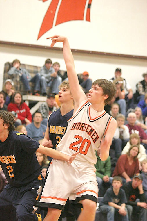 &lt;p&gt;Sophomore Aaron Baker takes a shot over a few Wardens players on Dec. 21 in Plains.&lt;/p&gt;