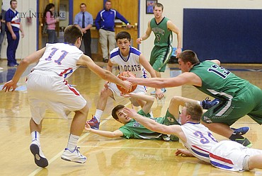 <p>The Wolfpack and Wildcats scramble for a loose ball during the fourth quarter of Glacier's 47-46 victory in Columbia Falls on Thursday. (Aaric Bryan/Daily Inter Lake)</p>