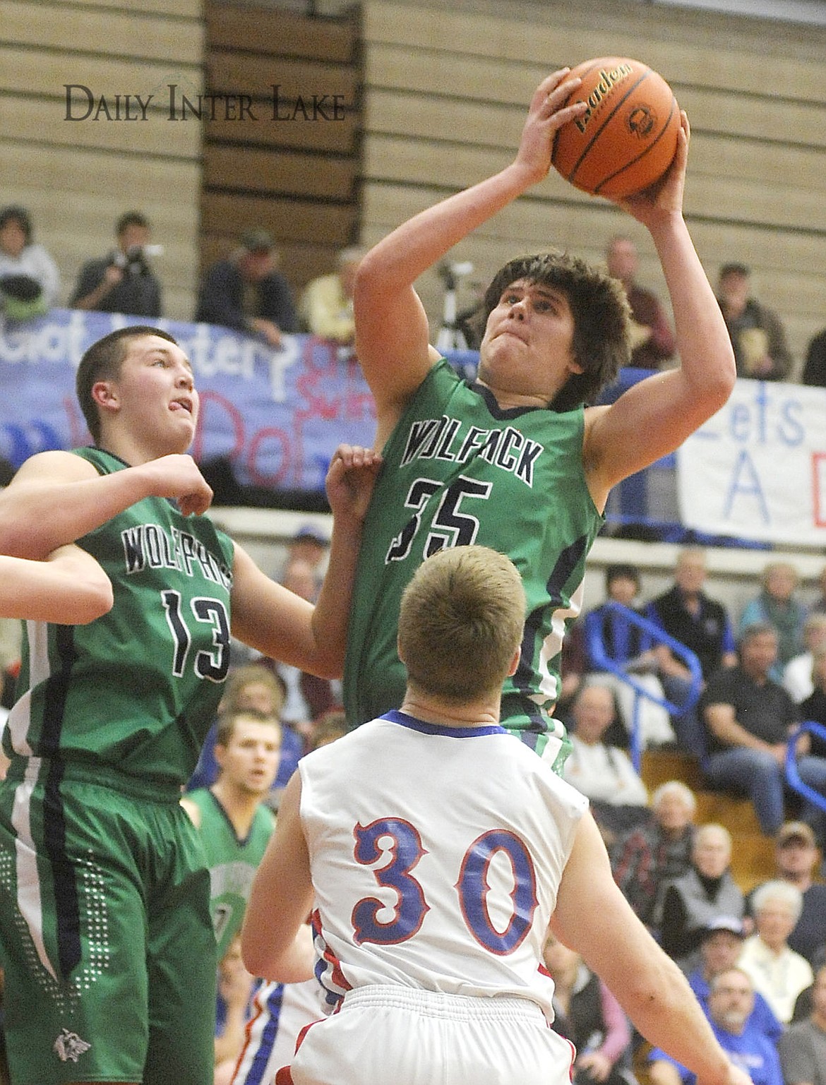 <p>The Wolfpack's Truman Pisk pulls down a rebound orver the Wildcats' Ty Morgan during the third quarter of Glacier's 47-46 win in Columbia Falls on Thursday. (Aaric Bryan/Daily Inter Lake)</p>