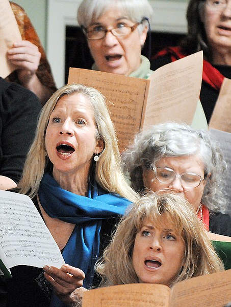 Lucy Smith, left, andSusan Guthrie, lower right, and member of the Crown of the Continent Choir singing at the community Thanksgiving dinner on Sunday, November 21, at the Epworth Methodist Church in Kalispell.
