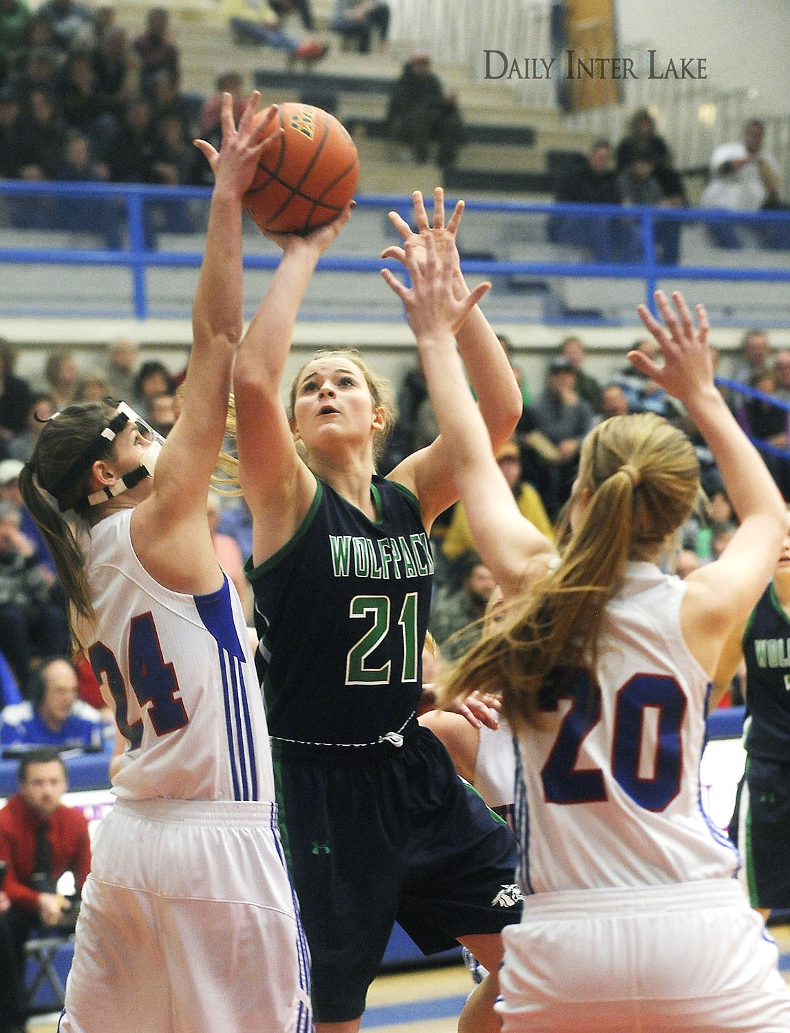 <p>Glacier's Brielle Bumgarner (21) puts up a shot between Columbia Falls' Winter Kemppainen (24) and Cydney Finberg at Columbia Falls on Thursday. (Aaric Bryan/Daily Inter Lake)</p>