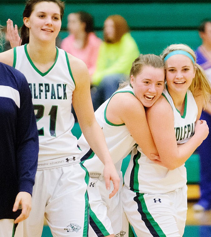 <p>Teammates celebrate with Katie Thomas (23) after she made the game winning shot Thursday night during Glacier's matchup against Columbia Falls at Glacier High school. Jan. 16, 2014 in Kalispell, Montana. (Patrick Cote/Daily Inter Lake)</p>