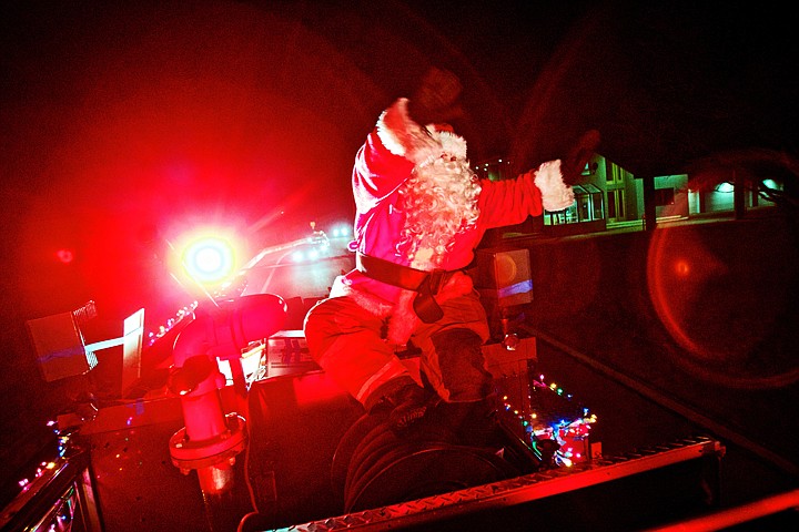 &lt;p&gt;JEROME A. POLLOS/Press Santa Claus waves to residents in the Fort Grounds neighborhood while touring the area on top of a fire engine Monday during the first night of the Coeur d'Alene Fire Department's mobile Santa food drive. The fire engine, Santa and his helpers will be touring neighborhoods tonight through Friday collecting food items and spreading holiday cheer with music and a brightly decorated fire engine. Schedule: Tonight Santa will tour neighborhoods east of Seventh Street and south of Best Avenue Wednesday Santa will tour neighborhoods east of Highway 95 and north of Appleway Thursday Santa will tour neighborhoods west of Highway 95 north of Appleway and south of Dalton Avenue Friday Santa will tour neighborhoods west of Highway 95 north of Dalton Avenue and south of Prairie Avenue&lt;/p&gt;