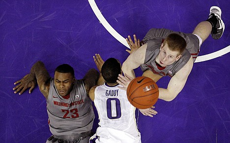 &lt;p&gt;Washington State's Brock Motum, right, eyes a loose ball as D.J. Shelton (23) and Washington's Abdul Gaddy hit the floor after colliding in the first half Sunday in Seattle.&lt;/p&gt;