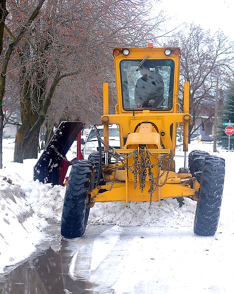 A snow plow clears 2nd Avenue E N on Friday afternoon in Kalispell. City Street Foreman Clint Speer said there is no feasible way for the snow plows to plow or skip nine thousand driveways. As things currently stand 10 employees cover routes that take between 30 and 34 hours to clear. When storms set in all employees work two 13 plus hour days to get their routes clear.