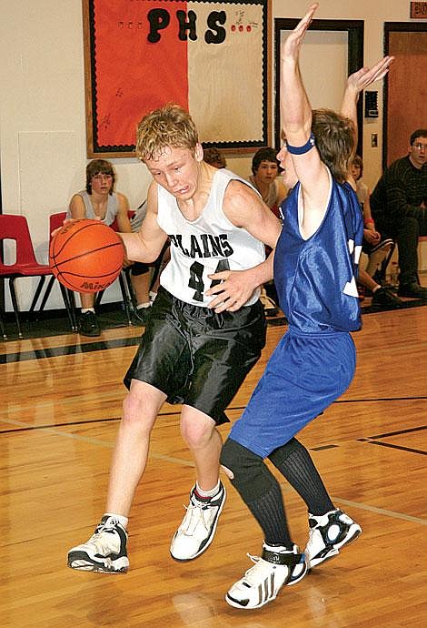 Photo by Ed Moreth&lt;br&gt;Plains Horseman Eric Rummel makes his way around Thompson Falls Bluehawk Garrett Reinschmidt during a junior high game Saturday at Plains, where the Horsemen won 27-22.