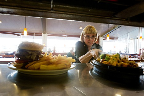 &lt;p&gt;Shirley Prosch picks up her last order from the window as a server at Denny's.&lt;/p&gt;