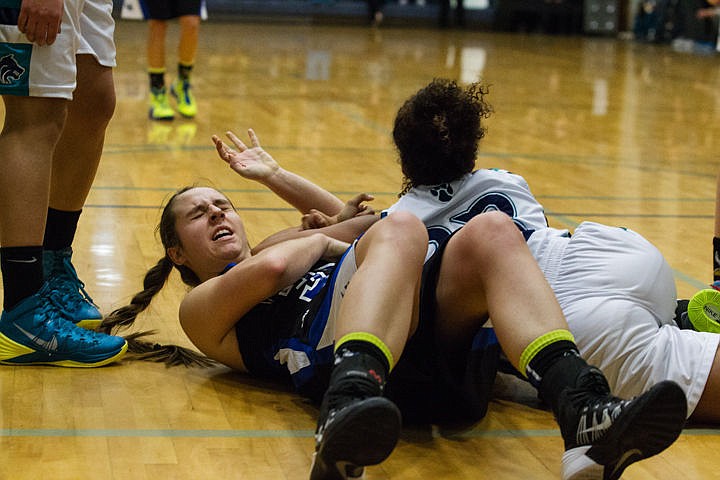 &lt;p&gt;Coeur d'Alene's Isabella Hollibaugh (33) and Lake City's Whitney Meier (23), wrestle for the ball at the fight for &quot;The Fish&quot; game Friday night at Lake City High School.&lt;/p&gt;