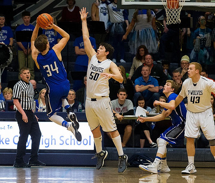 &lt;p&gt;Coeur d&#146;Alene&#146;s Tony Naccarato (34) puts up a two-point jumper over Lake City&#146;s Nick Hancock (50).&lt;/p&gt;