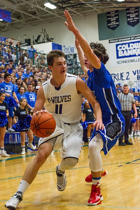 &lt;p&gt;Michael Goggin (11) dribbles past Brody Lundblad (2) going for a layup.&lt;/p&gt;