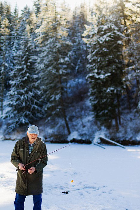 &lt;p&gt;Bill Tarnasky prepares to drop his line after baiting a hook with cheddar cheese Wednesday on his first ice fishing outing on Fernan Lake.&lt;/p&gt;