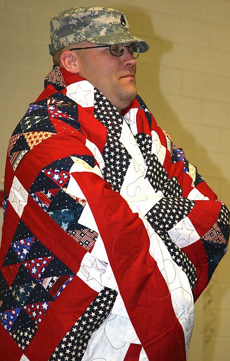 &lt;p&gt;Staff Sgt. Ryan Rogers of Post Falls tries out his new quilt after receiving it from the Quilts of Valor on Sunday.&lt;/p&gt;