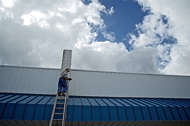 &lt;p&gt;Wayne Reichenberg, with Fourth Street Electric, clears out electrical conduit under a cloudy sky Wednesday in preparation for the installation of a display sign for Paris Flea Market's new location on Fourth Street near Poplar Avenue in midtown Coeur d'Alene.&lt;/p&gt;