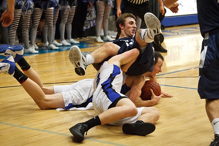 &lt;p&gt;SHAWN GUST/Press Lake City's Mitch Bevacqua lands on Coeur d'Alene High School's Ty Higbie after getting knocked down by another Coeur d'Alene player in the fourth quarter Friday during the Fight for the Fish cross-town rivalry boy's game.&lt;/p&gt;