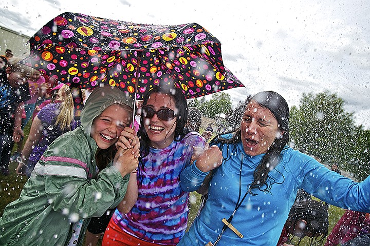 &lt;p&gt;Eryn Garrett, 8, tries to share her umbrella&#160;with second grade teachers Jessica Lamb, center, and Michelle Faucher-Sharples during a celebration for Mullan Trail Elementary students May 29 in Post Falls. Kootenai County Fire and Rescue firefighters used a ladder truck to spray students with water to help celebrate the school's recent 5,200-pound donation for the Post Falls Food Challenge. Students teamed up with the fire department for their &quot;Burn Out Hunger&quot; food drive.&lt;/p&gt;