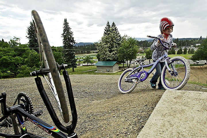 &lt;p&gt;Lilian Tucker, 8, pushes her bicycle up to the starting gate Tuesday on the BMX track at Cherry Hill Park in Coeur d'Alene. (JEROME A. POLLOS/Press)&lt;/p&gt;