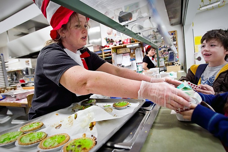 &lt;p&gt;JEROME A. POLLOS/Press Mia Bashaw serves up green eggs and ham quiche to a student while Chris Prosser, 7, waits his turn in line in the Bryan Elementary cafeteria.&lt;/p&gt;