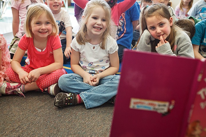 &lt;p&gt;SHAWN GUST/Press Dakota Budd, far left, Cayci Engelbrecht, and Kaylen Triana, right, react while listening to a reading of Dr. Seuss' &quot;The Tooth Book&quot; Tuesday at Frederick Post Kindergarten in Post Falls. Life Care Center staff and clients visited the youngsters to read Dr. Seuss stories and deliver cookies. The Post Falls senior care center helps sponsor the class taught by Tracie Schmidt.&lt;/p&gt;