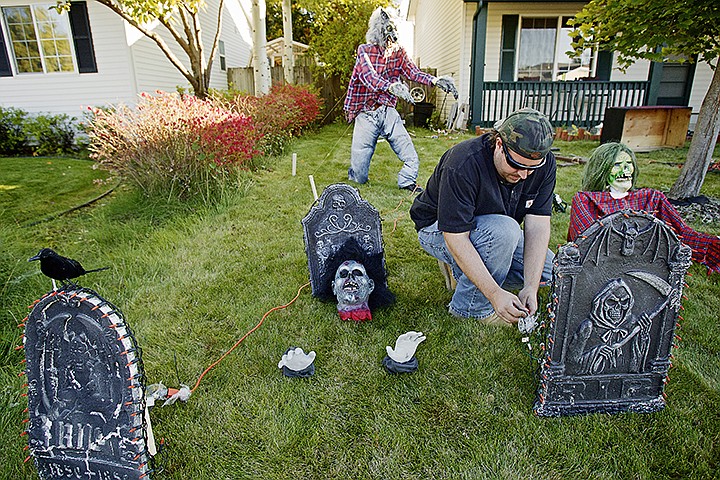 &lt;p&gt;&#160;Shawn Lambert connects one of the 16 extension cords he has running across his lawn Friday to power the lights and operate an animatronic skeleton for his Halloween display in front of his Coeur d'Alene home. Lambert, who's spent more than 40 hours constructing, assembling and programming the various components to operate his display, will operate the attracting daily through Halloween at 964 West Fallview Drive in Coeur d'Alene. &quot;I grew up going to Disneyland and now I'm enthralled with doing this stuff,&quot; Lambert said about his display.&lt;/p&gt;