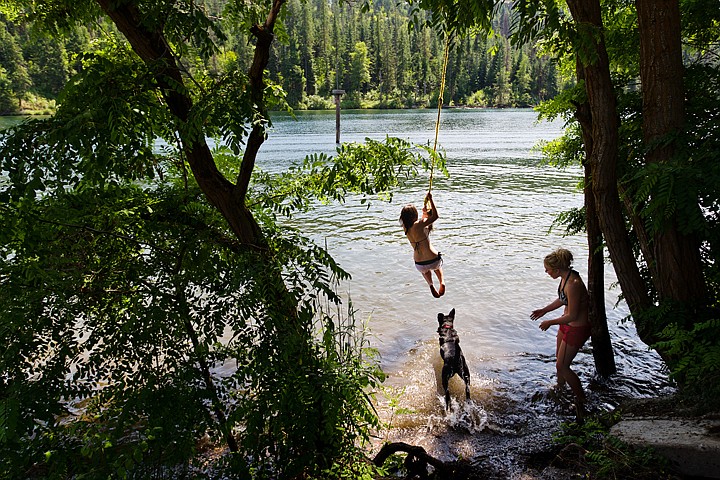 &lt;p&gt;Heather Fiegener, 17, calls for Tsayta, a young black lab, as Francesca Hyslop, 16, swings from a rope before splashing into the Spokane River Monday in Coeur d'Alene.&lt;/p&gt;