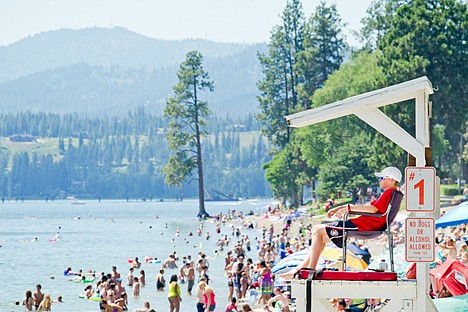 &lt;p&gt;Carson May watches over the crowded City Beach in Coeur d'Alene during his midday shift on Sunday. May has been a lifeguard for three weeks and says he enjoys the heat but being in his covered guard tower makes it a bit cooler. Sunday's high temperature was 96 degrees.&lt;/p&gt;