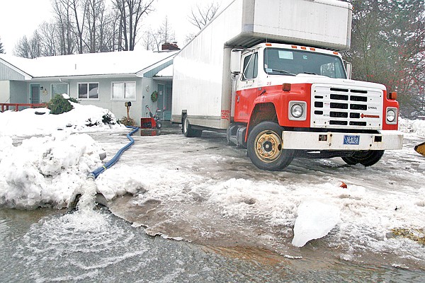 By early afternoon, flood victims began pumping water out of their basements. Don Emery, whose rental home is pictured, also began packing his belongings into a moving truck.