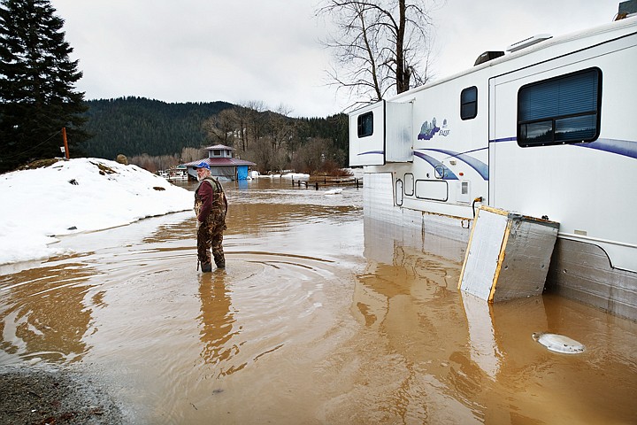 &lt;p&gt;Richard White wades into the rising waters of the Coeur d'Alene River to gather some loose items before they flow downstream.&lt;/p&gt;