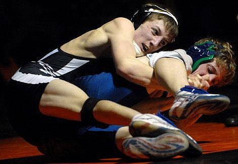 Flathead&#146;s Dan Jenkins, left, grapples with Glacier&#146;s Stormy Day during their 125-pound match at Flathead on Thursday. Garrett Cheen/Daily Inter Lake