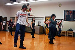 Eddie Stugelmayer and Rachel Ibarra take direction from zumba instructor Amy Anderson.