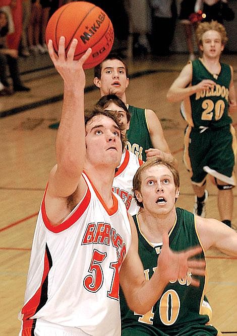 Flathead&#146;s Brock Osweiler heads for the basket while Whitefish Bulldog Jamie Clogg defends during Thursday night&#146;s game in Kalispell. Osweiler contributed 20 points to Flathead&#146;s win over Whitefish. In the background are Whitefish players Colt Idol and Luke Fennelly. Karen Nichols/Daily Inter Lake