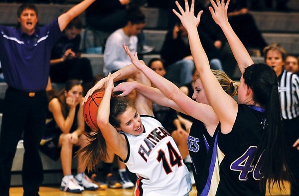 Flathead&#146;s Tess Brenneman loses control of the ball while being overwhelmed by two Polson defenders during Tuesday evening&#146;s nonconference game at Flathead High School.