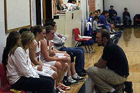 Trotter head coach Richard Griffin addresses his bench during Friday's loss against the visiting Mission Bulldogs as Ashley Holmes, Kelsey Beagley, Aspen Rude, Jessica Read, Kayla Revier and Jessica Hanson listen attentively.