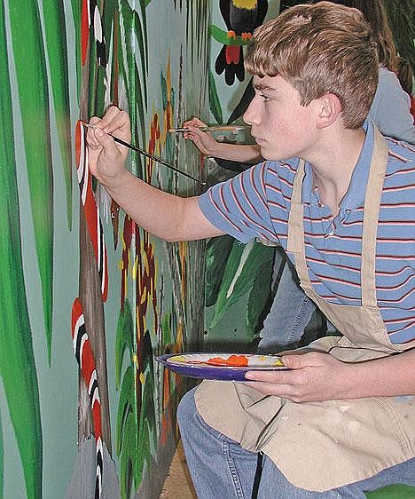 Libby Middle School student Konnor Basso paints the set for &quot;The Jungle Book Kids.&quot;