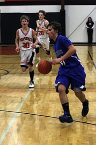 Bluehawks guard Garrett Reinschmidt gets out in front of Taylor Firestone and Andrew Baker of Plains in transition.